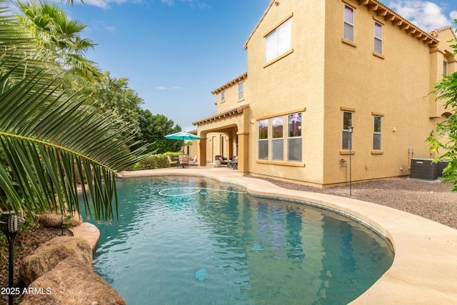 view of swimming pool with central AC unit and a patio area