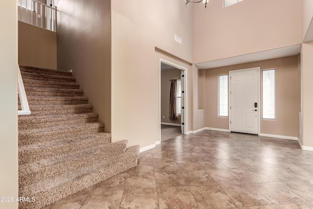 entrance foyer with a chandelier and a high ceiling