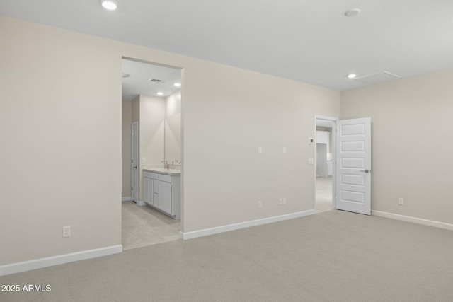 empty room with baseboards, visible vents, light colored carpet, and recessed lighting