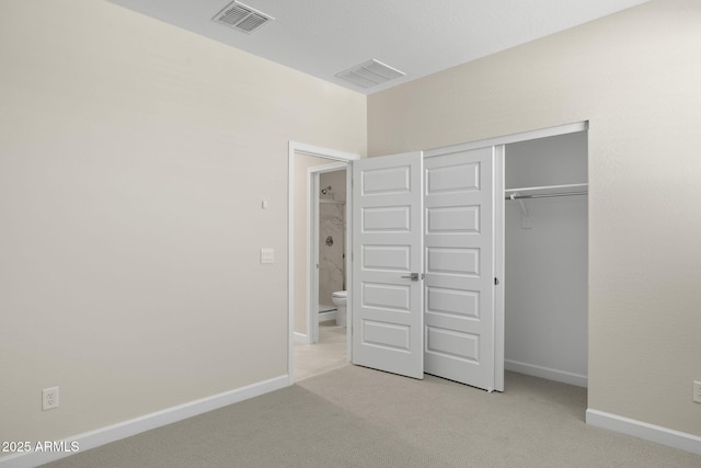 unfurnished bedroom with carpet floors, baseboards, and visible vents