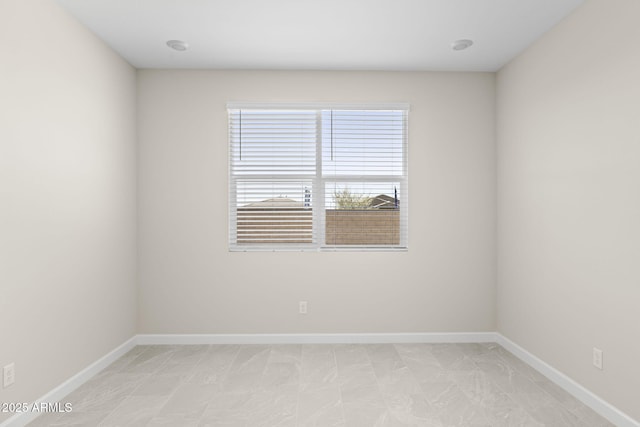 spare room featuring baseboards