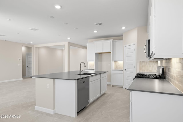 kitchen featuring stainless steel appliances, dark countertops, visible vents, and a sink