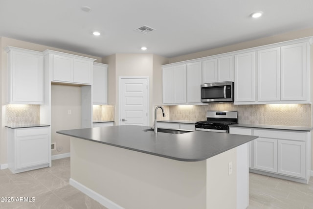 kitchen featuring stainless steel appliances, a sink, visible vents, and white cabinetry