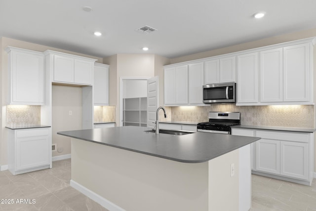 kitchen featuring visible vents, appliances with stainless steel finishes, white cabinets, and a sink