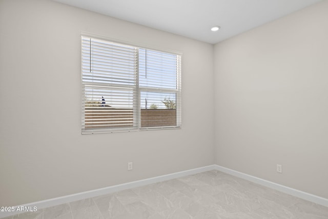 spare room with baseboards