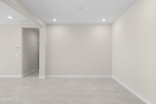 below grade area with baseboards and recessed lighting