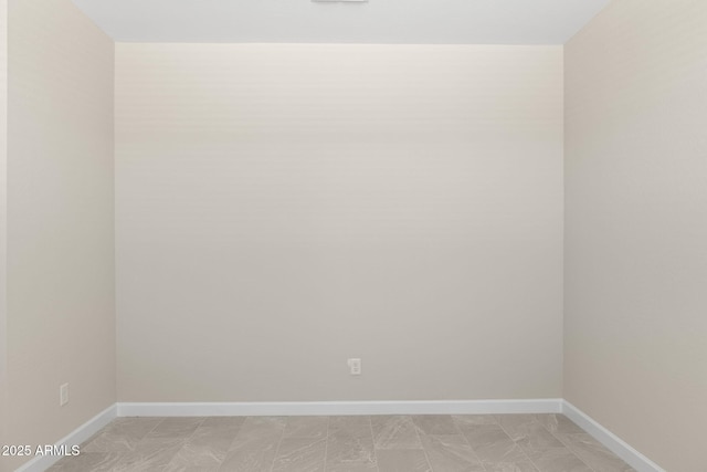 empty room featuring baseboards