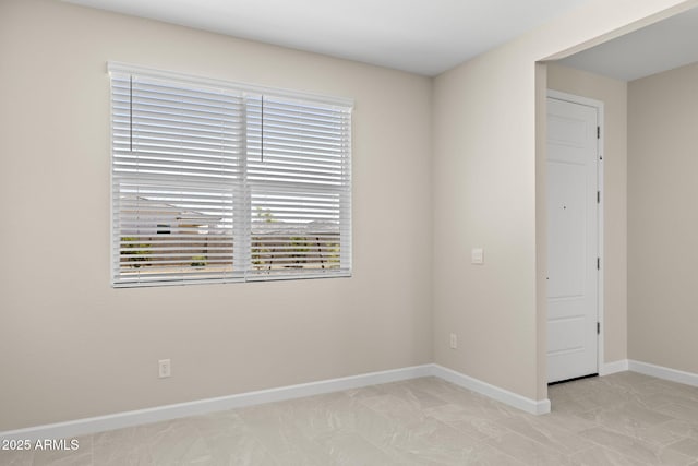 empty room featuring baseboards