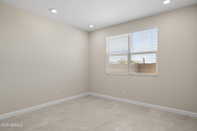 empty room with recessed lighting and baseboards