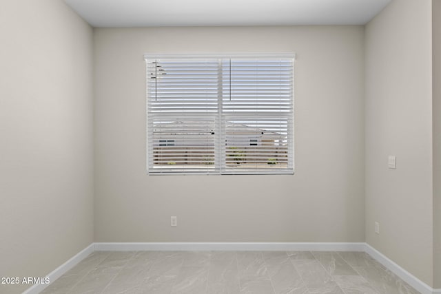 empty room featuring baseboards