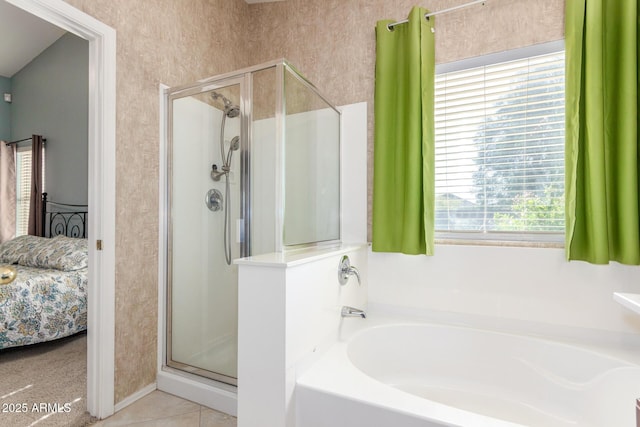 full bathroom featuring a garden tub, ensuite bath, a stall shower, and tile patterned flooring