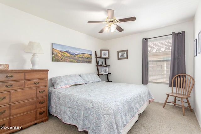 bedroom featuring light colored carpet, ceiling fan, and baseboards