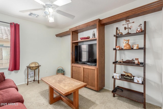 living room with light colored carpet, visible vents, ceiling fan, and baseboards