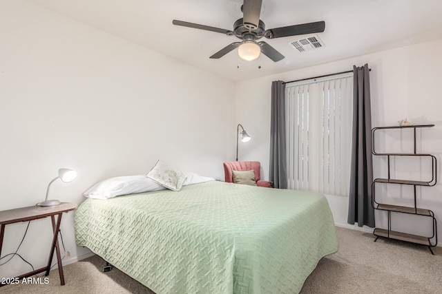 carpeted bedroom with baseboards, ceiling fan, and visible vents