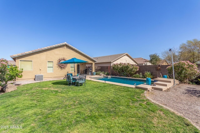 view of pool with a fenced backyard, a fenced in pool, central air condition unit, and a lawn