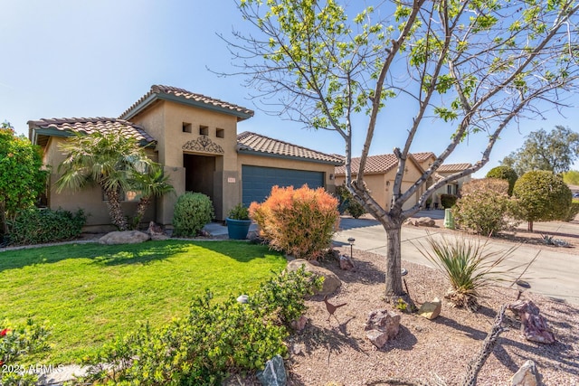 mediterranean / spanish-style house with a tiled roof, stucco siding, an attached garage, and concrete driveway