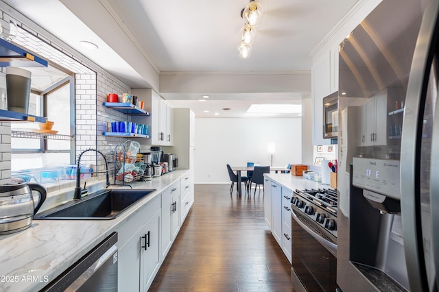 3465 N Jamison Blvd Unit 05, Flagstaff, AZ 86004 - kitchen featuring appliances with stainless steel finishes, a sink, open shelves, dark wood-type flooring, and white cabinetry