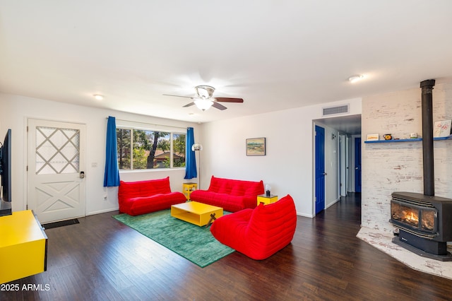 3465 N Jamison Blvd Unit 05, Flagstaff, AZ 86004 - living area featuring a wood stove, wood finished floors, a ceiling fan, and baseboards