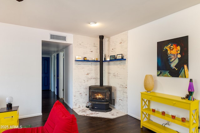 3465 N Jamison Blvd Unit 05, Flagstaff, AZ 86004 - living area featuring a wood stove, wood finished floors, and baseboards