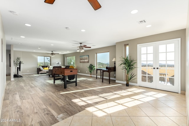 interior space with french doors, light hardwood / wood-style flooring, and ceiling fan