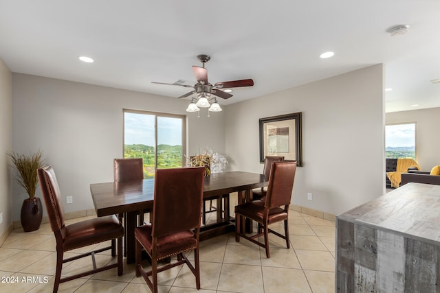 tiled dining room featuring ceiling fan