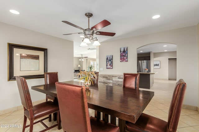 tiled dining space featuring ceiling fan