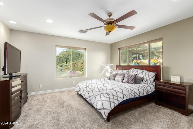 bedroom with light colored carpet and ceiling fan