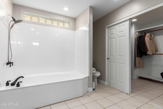 bathroom with toilet and tile floors