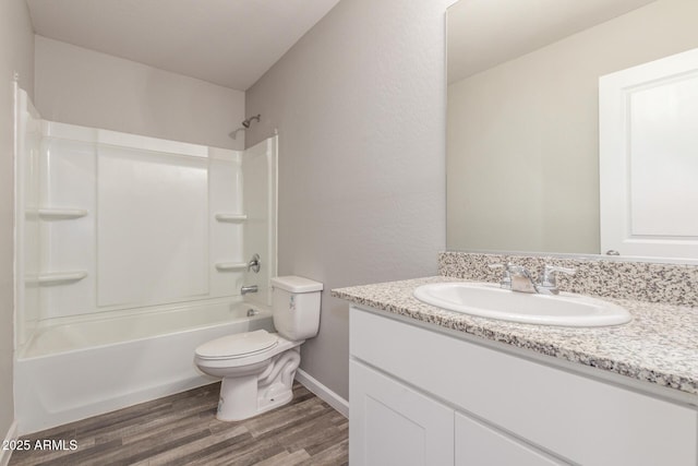 255 W Dewey Ave, Coolidge, AZ 85128 - bathroom featuring wood finished floors, toilet, vanity, and tub / shower combination