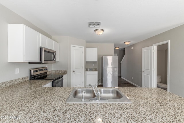 255 W Dewey Ave, Coolidge, AZ 85128 - kitchen featuring stainless steel appliances, a sink, and white cabinetry