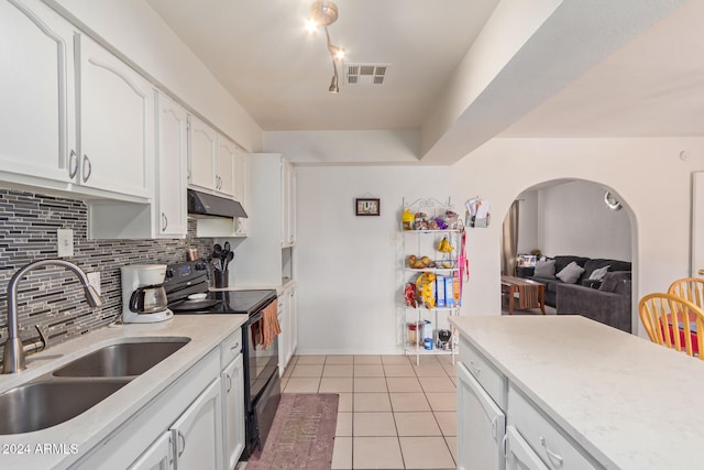 kitchen with white cabinetry, sink, light tile patterned floors, black electric range oven, and decorative backsplash