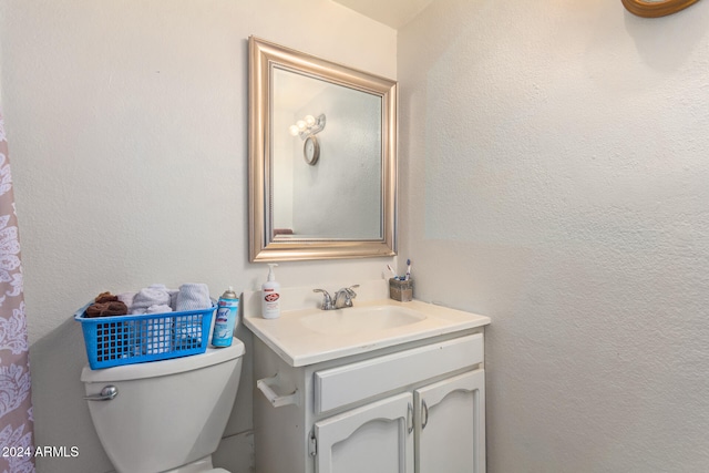 bathroom featuring vanity and toilet