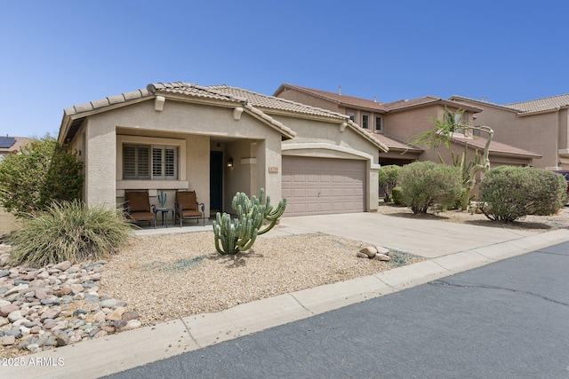 4718 E Woburn Ln, Cave Creek, AZ 85331 - view of front of property with stucco siding, a garage, concrete driveway, and a tile roof