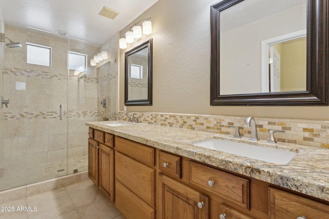 4718 E Woburn Ln, Cave Creek, AZ 85331 - bathroom with a stall shower, double vanity, backsplash, and tile patterned floors