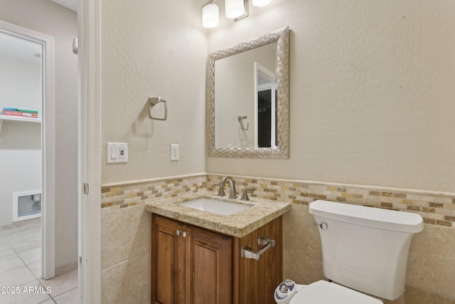 4718 E Woburn Ln, Cave Creek, AZ 85331 - half bath featuring tile walls, vanity, wainscoting, toilet, and tile patterned floors