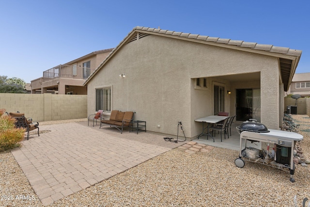4718 E Woburn Ln, Cave Creek, AZ 85331 - rear view of house with stucco siding, a patio area, and outdoor lounge area