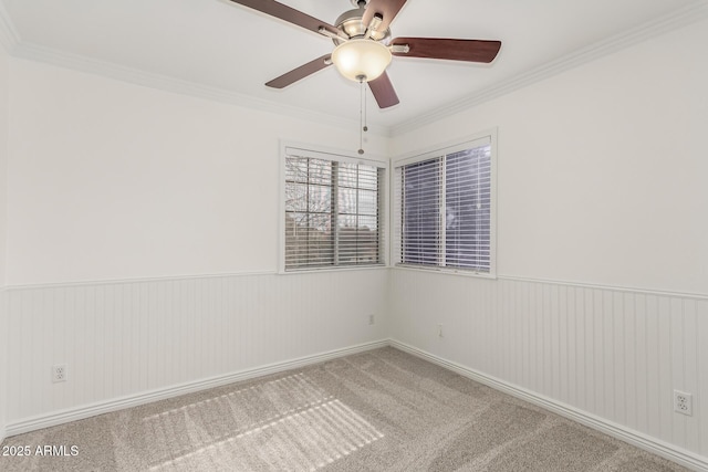 unfurnished room featuring ornamental molding and carpet flooring