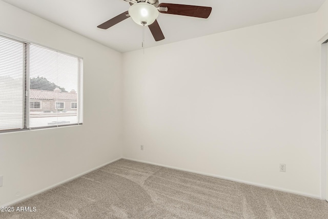 unfurnished room with ceiling fan and carpet flooring