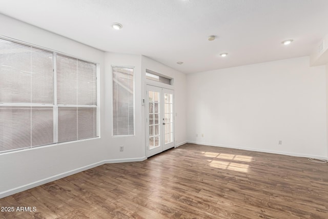 empty room with dark wood-type flooring and french doors