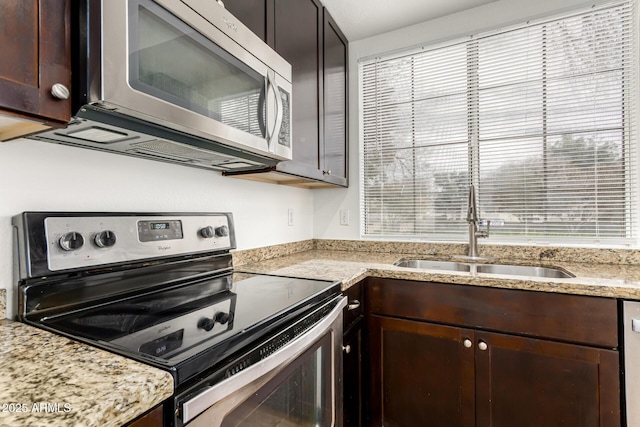 kitchen featuring stainless steel appliances, sink, and dark brown cabinets