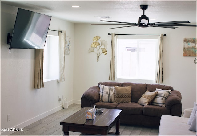 living room with ceiling fan and light hardwood / wood-style floors