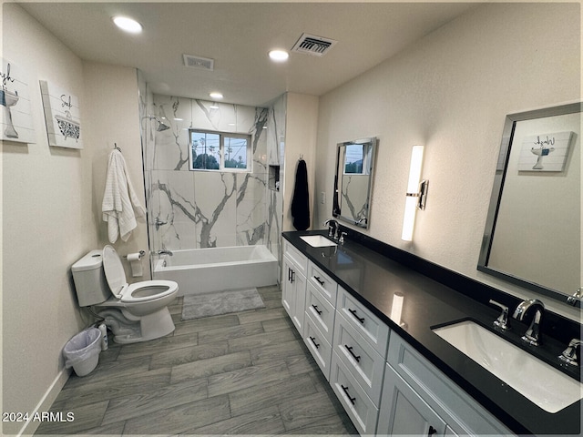 full bathroom with vanity, tiled shower / bath combo, toilet, and wood-type flooring