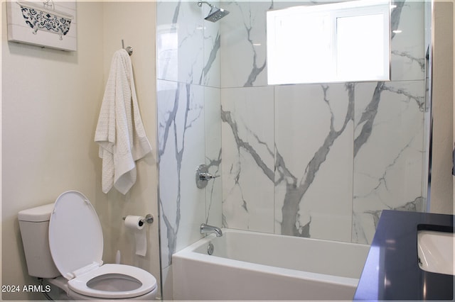 bathroom with toilet and tiled shower / bath combo