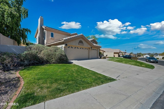 view of front of property with driveway, a garage, stucco siding, a tile roof, and a front yard