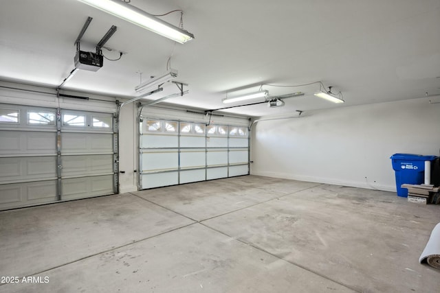 garage featuring a garage door opener and baseboards