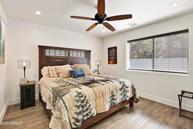 bedroom with ceiling fan and hardwood / wood-style floors