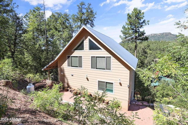 view of property exterior with a deck with mountain view