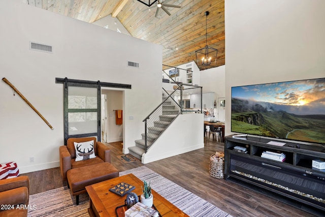 living room with wood ceiling, high vaulted ceiling, dark hardwood / wood-style floors, ceiling fan with notable chandelier, and a barn door