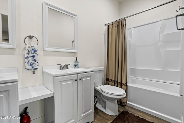 full bathroom with shower / bath combo, vanity, toilet, and hardwood / wood-style flooring