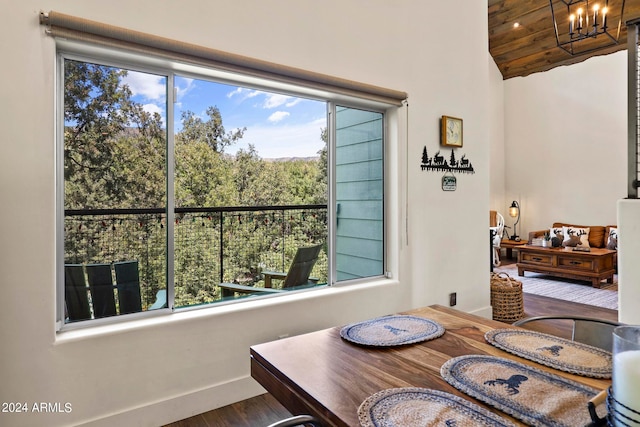 dining area with a notable chandelier, wooden ceiling, plenty of natural light, and hardwood / wood-style floors